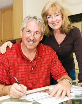 A person sign a document and smiling